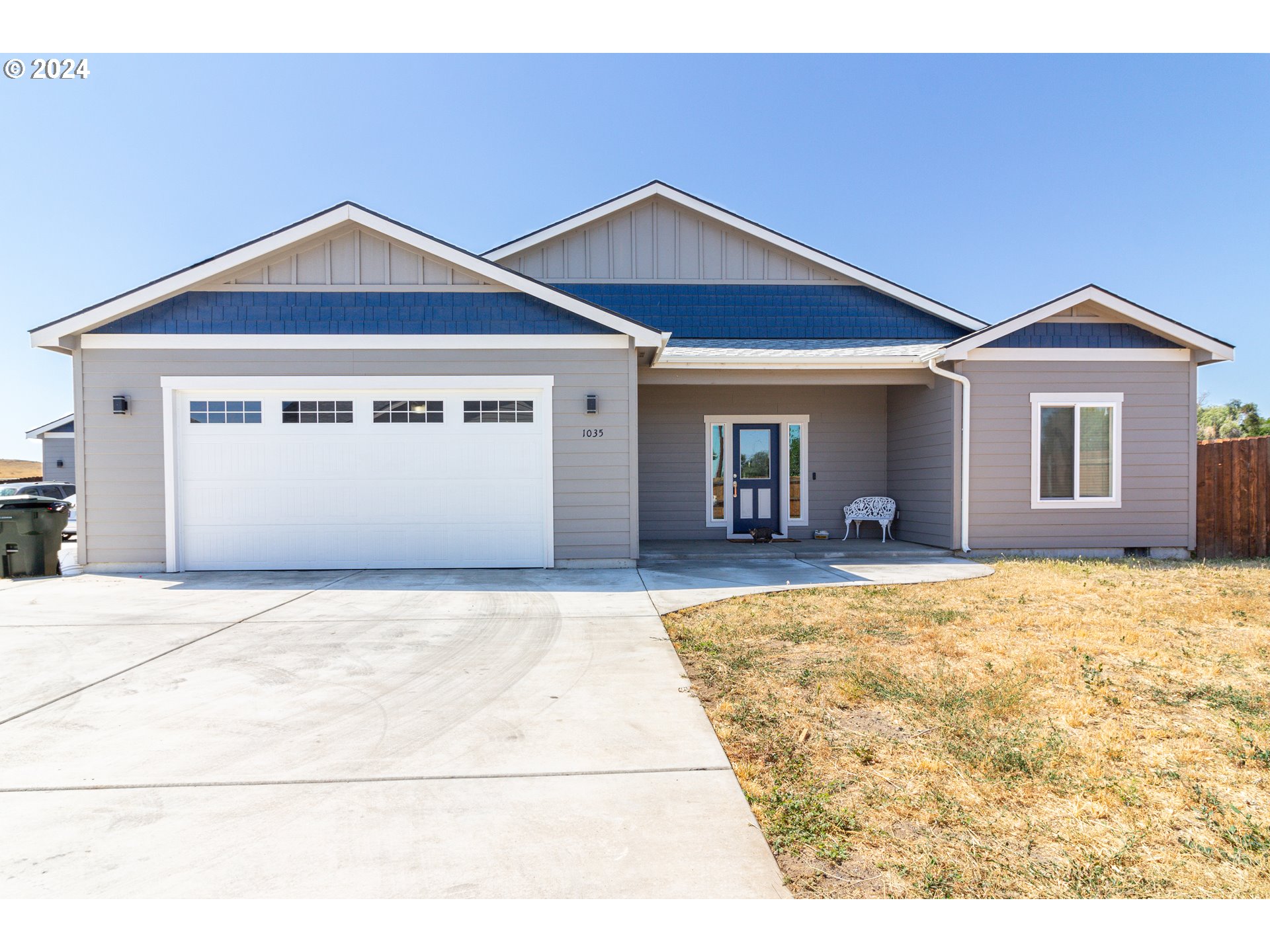 a view of a house with a yard and garage