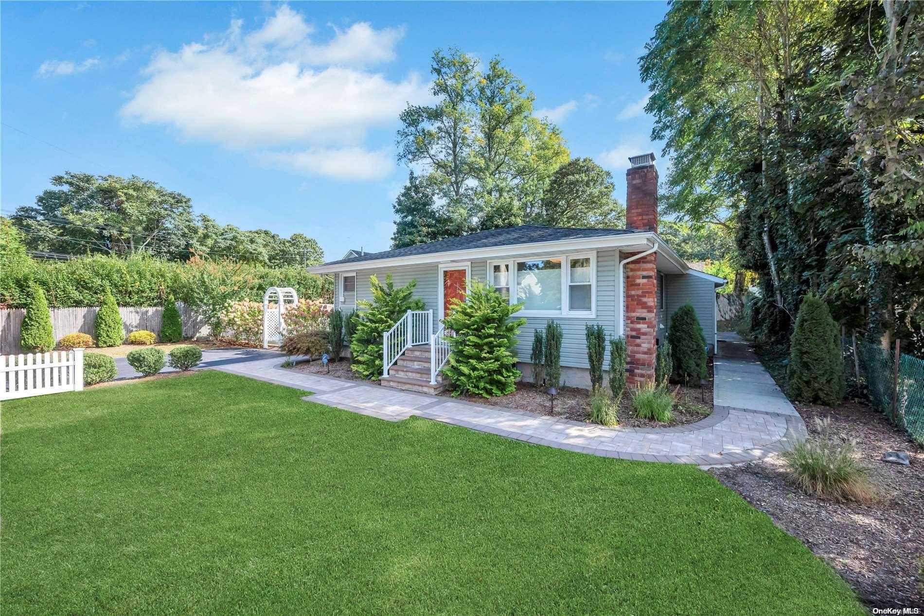 a view of a house with a yard and sitting area