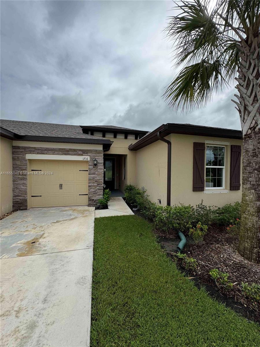 a house with a yard and a garage