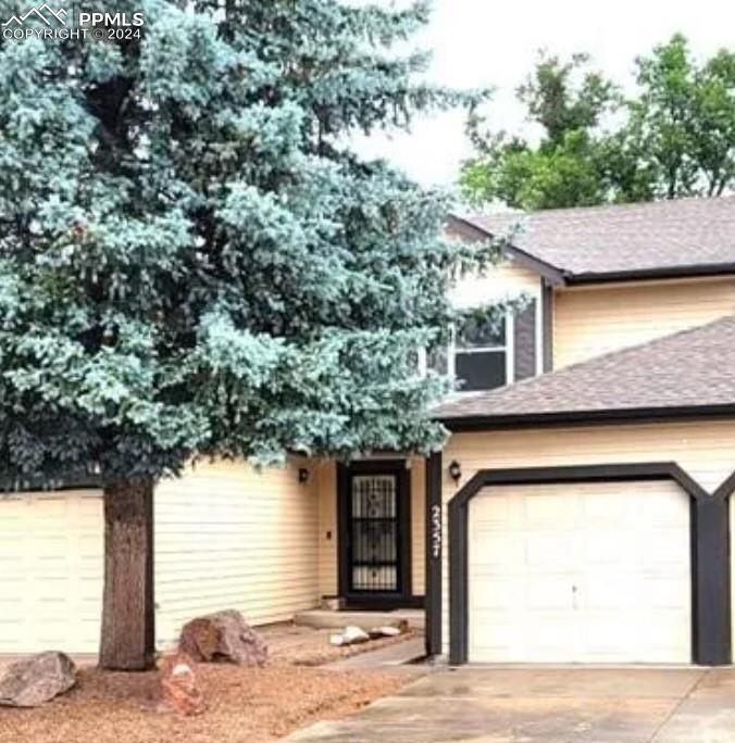 a front view of a house with a garage