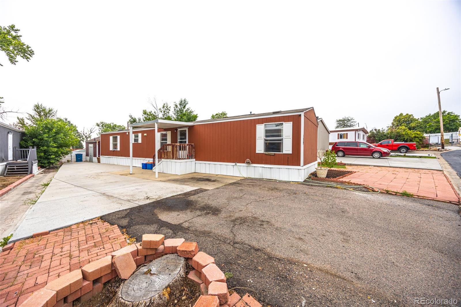 a view of house with outdoor space and parking