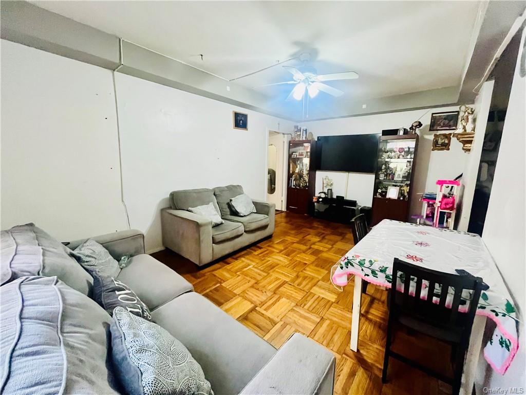 Living room with parquet floors and ceiling fan