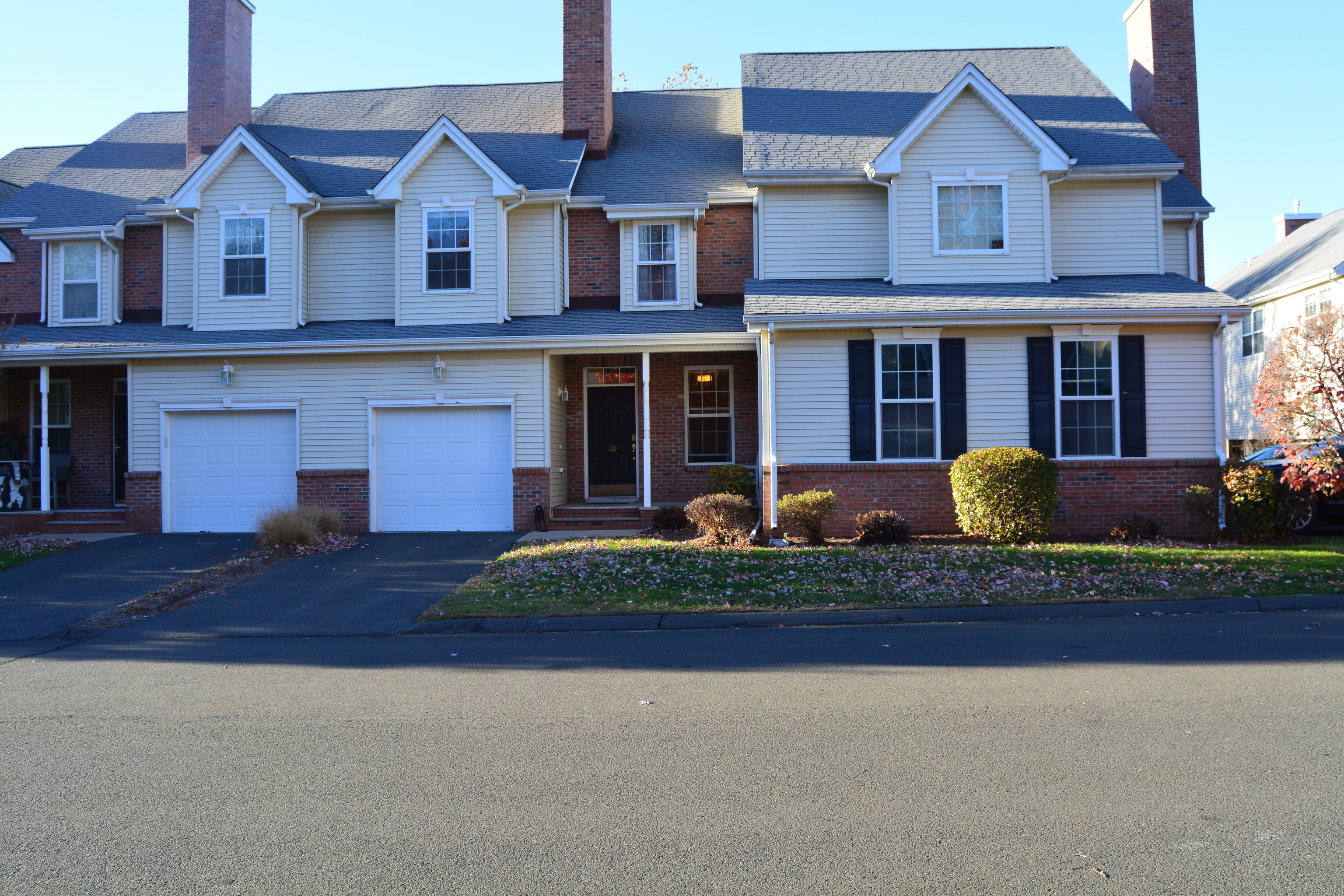 a front view of a house with garden and plants