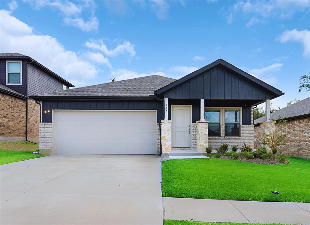 a front view of a house with a garden and yard