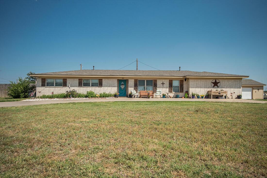 a front view of house with yard and seating space