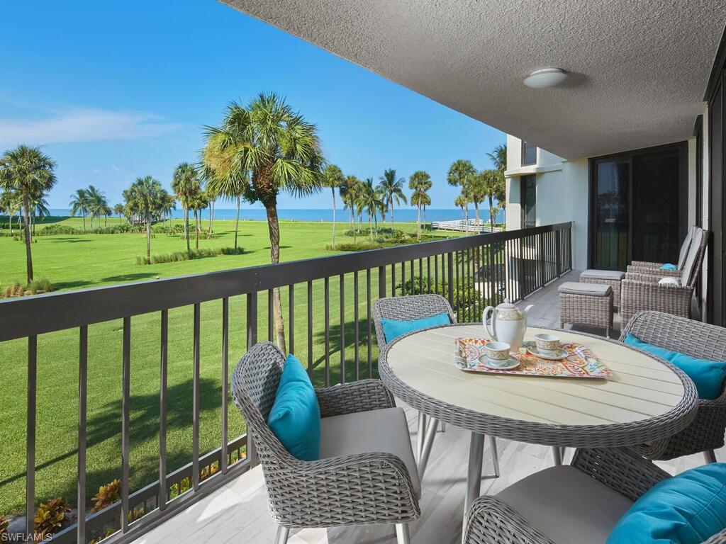 a view of a balcony with two chairs and a table