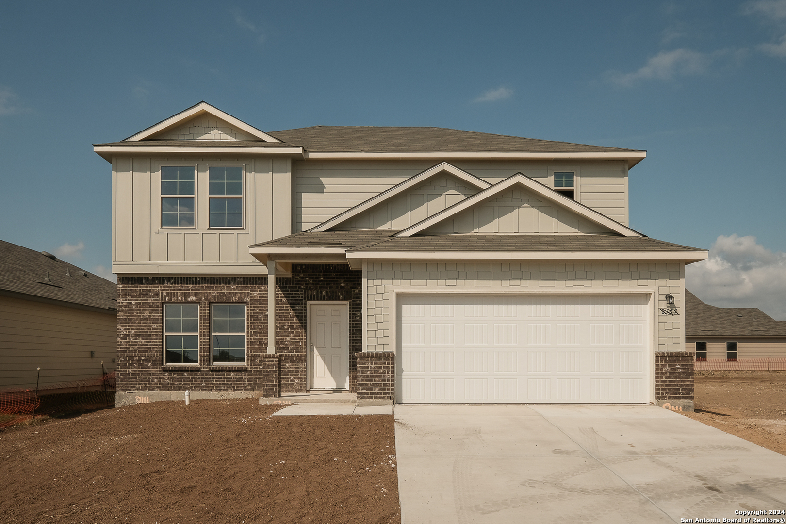 a front view of a house with garage