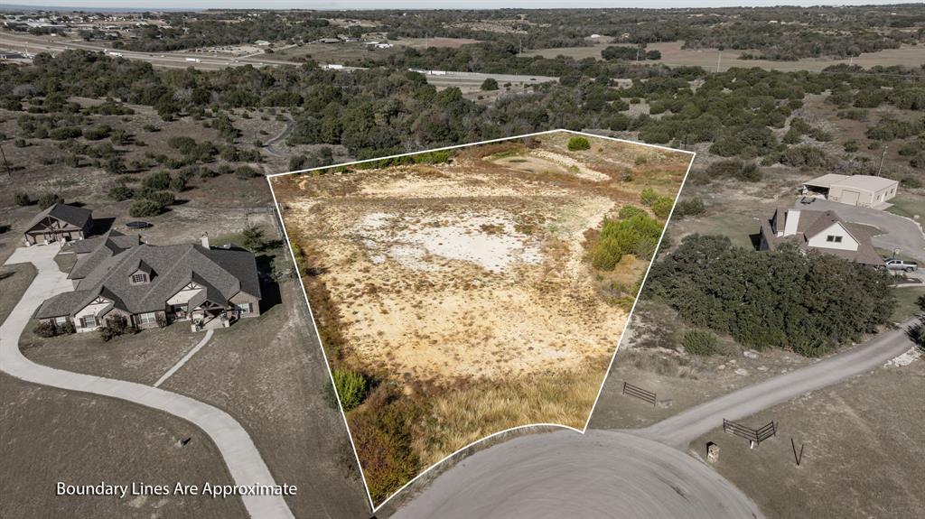 an aerial view of a house with yard