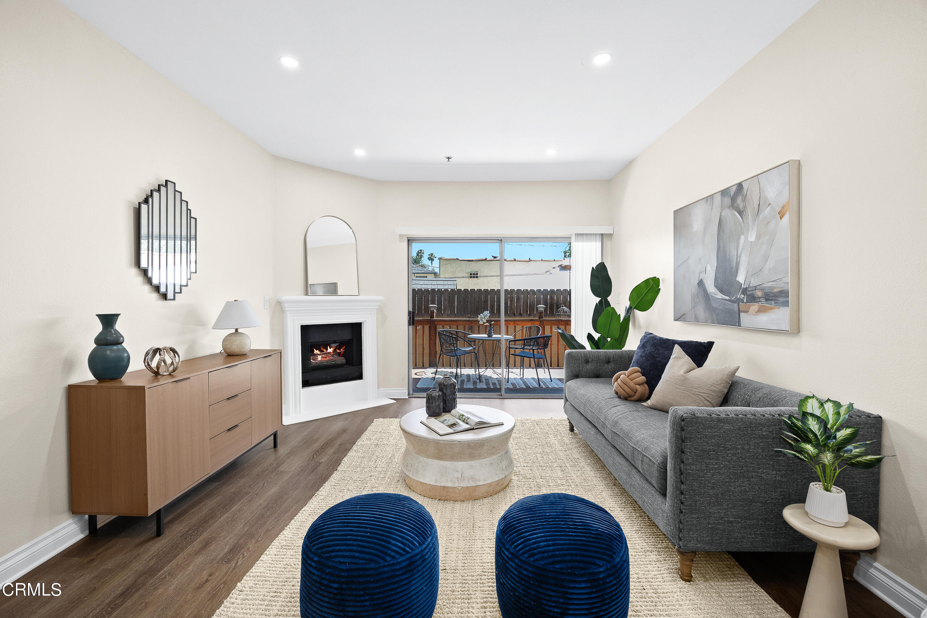 a living room with fireplace furniture and a large window