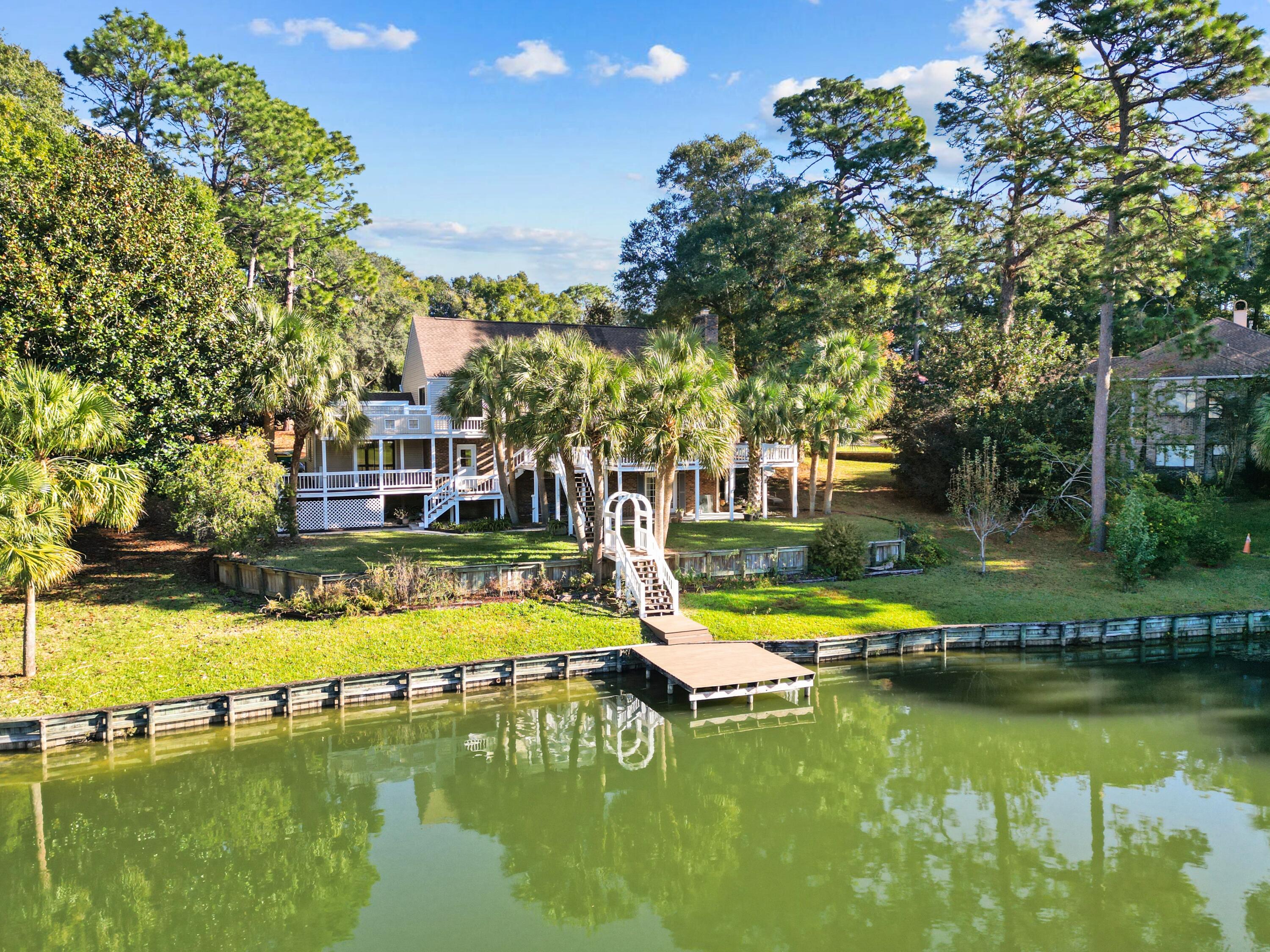 a view of an house with swimming pool and chairs