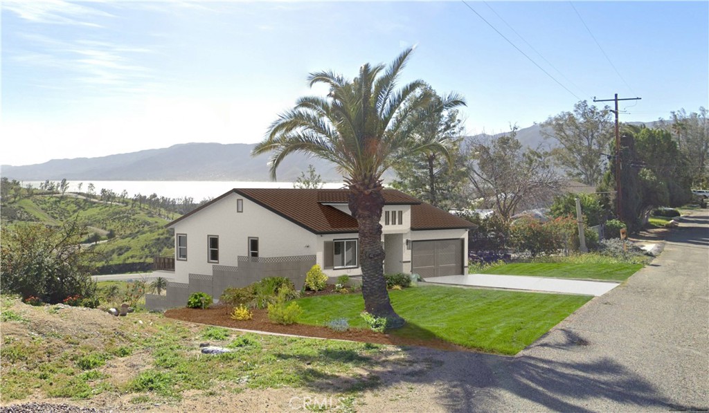 a view of a house with a yard and pathway