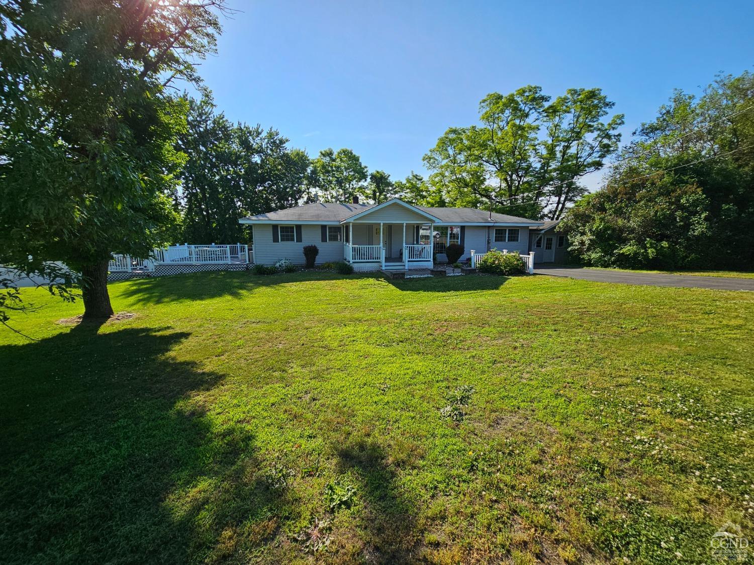 a view of a house with swimming pool and a yard