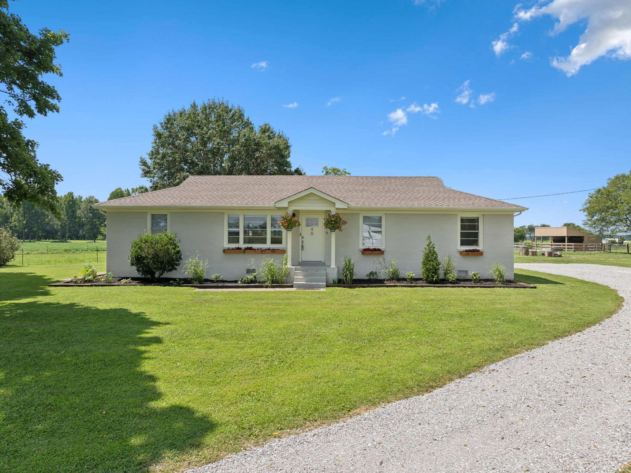 a front view of a house with a garden