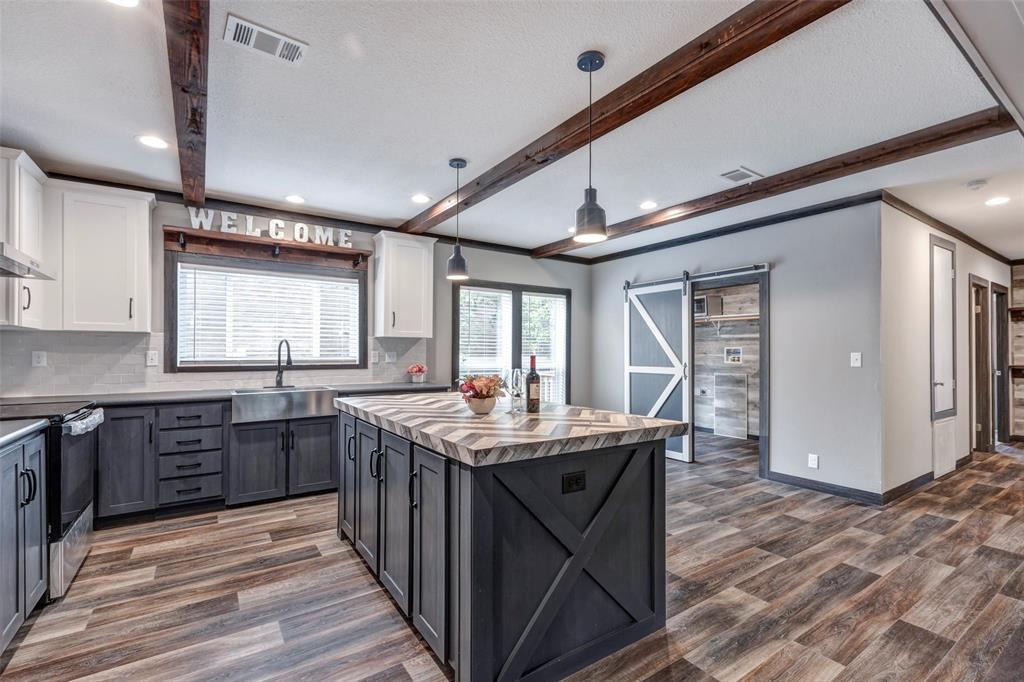 a kitchen with stainless steel appliances granite countertop a sink stove and cabinets