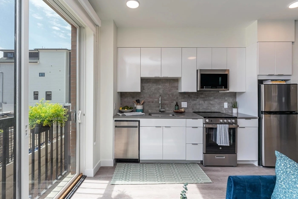 a kitchen with stainless steel appliances a stove a sink and a refrigerator