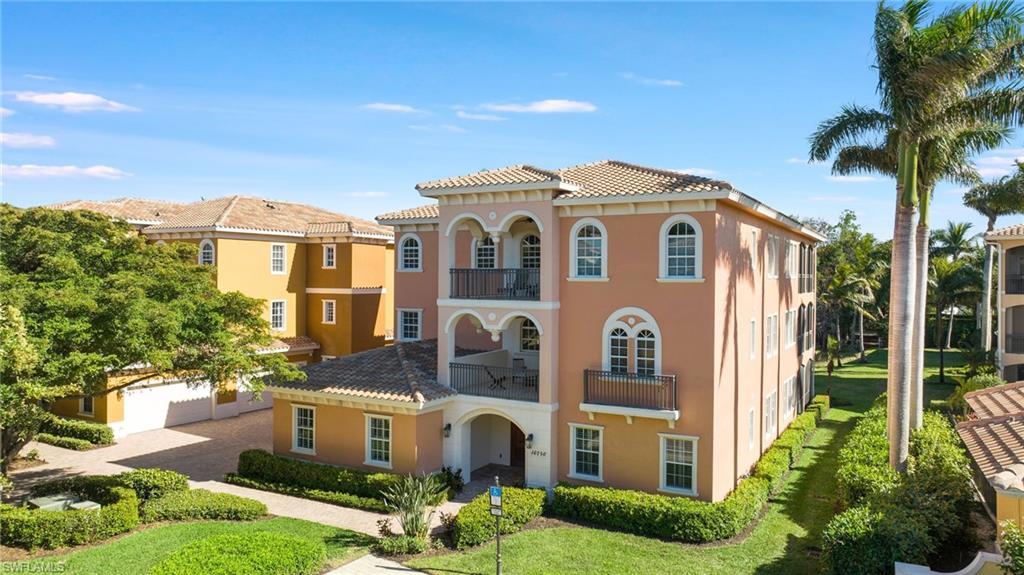 Mediterranean / spanish home with a balcony and a front yard