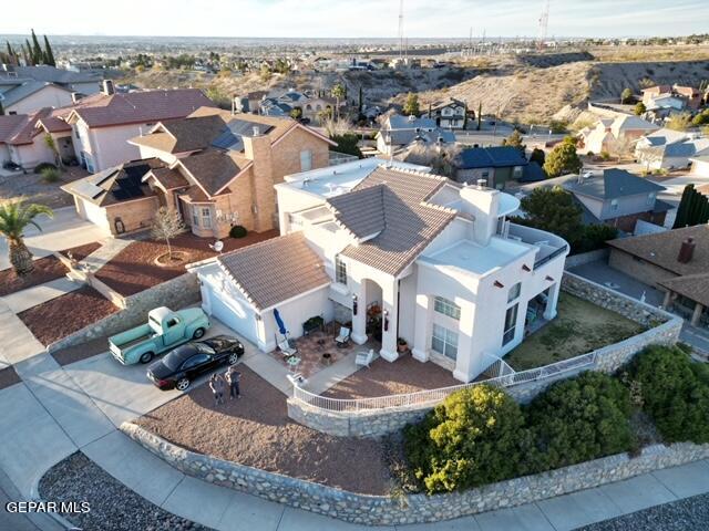 an aerial view of a house with a yard garage and lake view