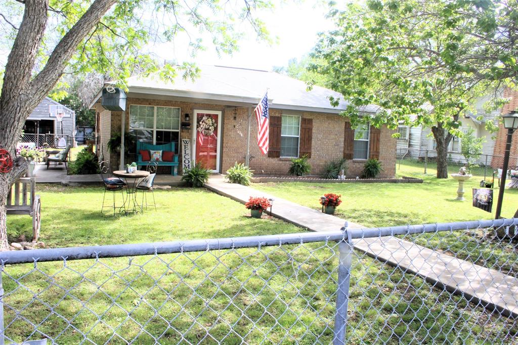 a view of a house with swimming pool and a yard