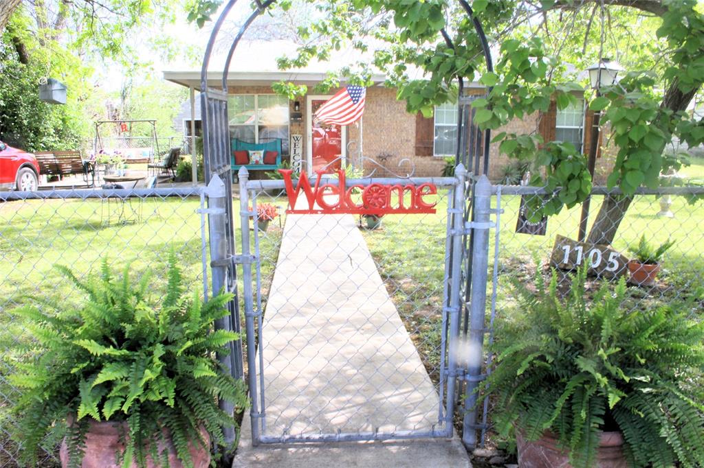 a front view of a house with a yard and fountain