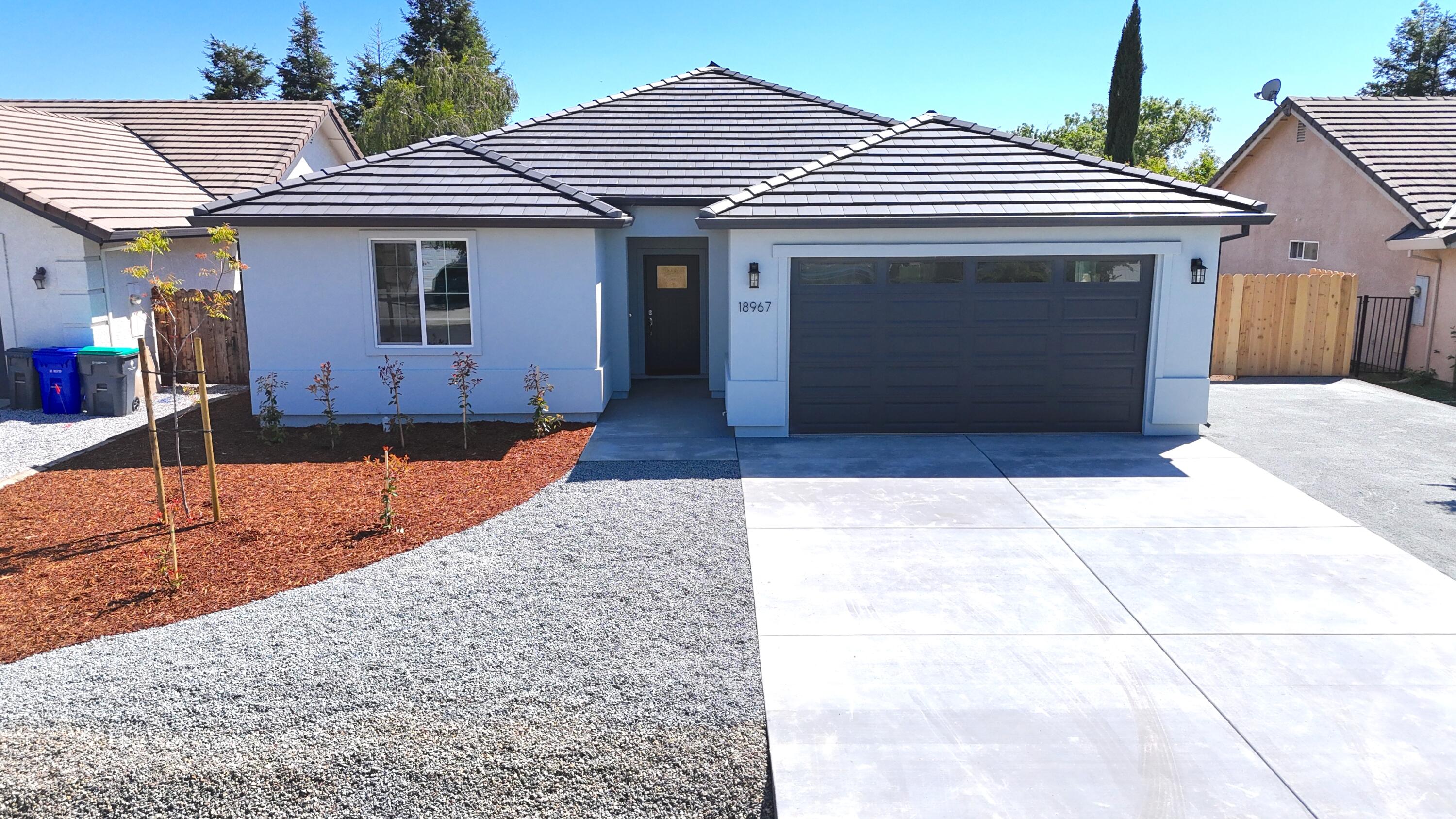 a front view of a house with garage