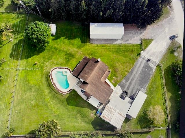 an aerial view of a house with garden space and street view