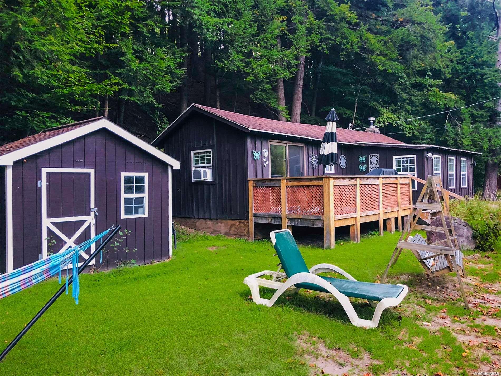 a view of a house with a yard chairs and a slide