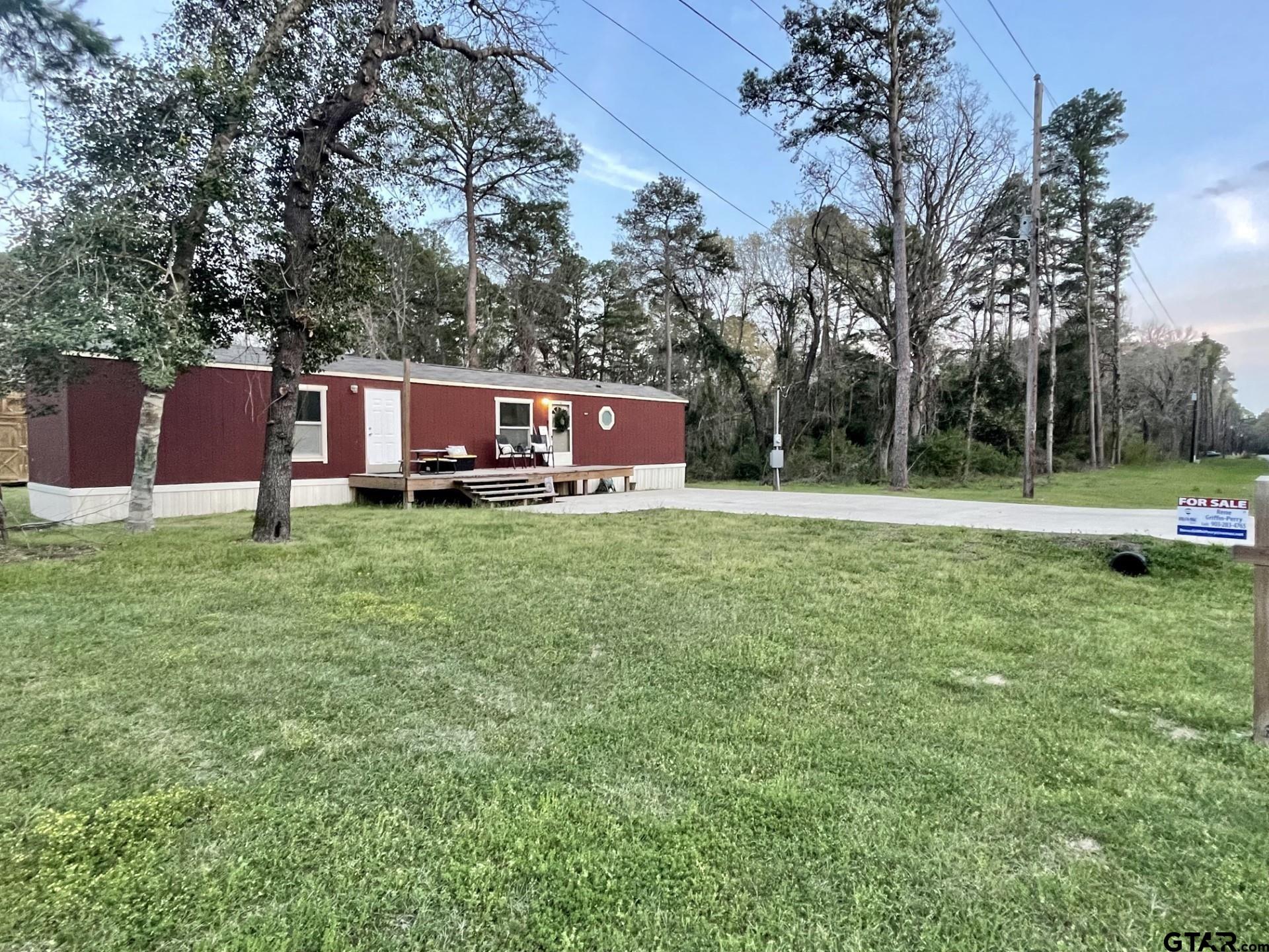 a view of a house with a backyard