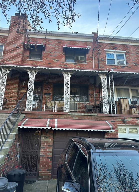 a view of a brick house with large windows