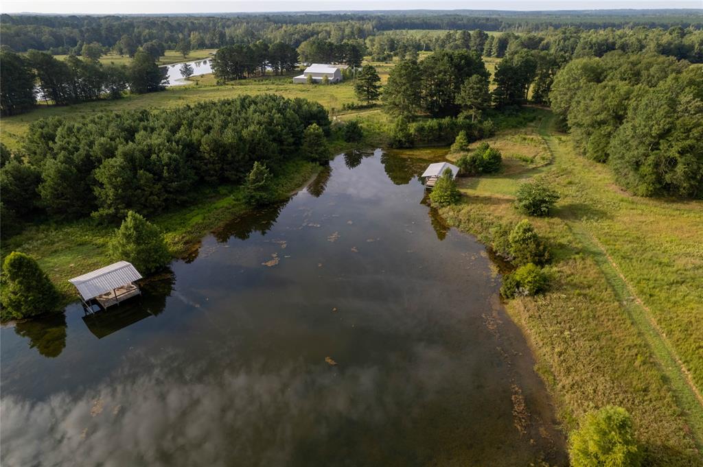 an aerial view of a house with a yard and lake view