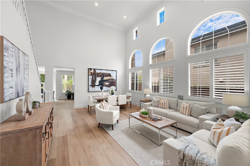 a living room with furniture wooden floor and a large window