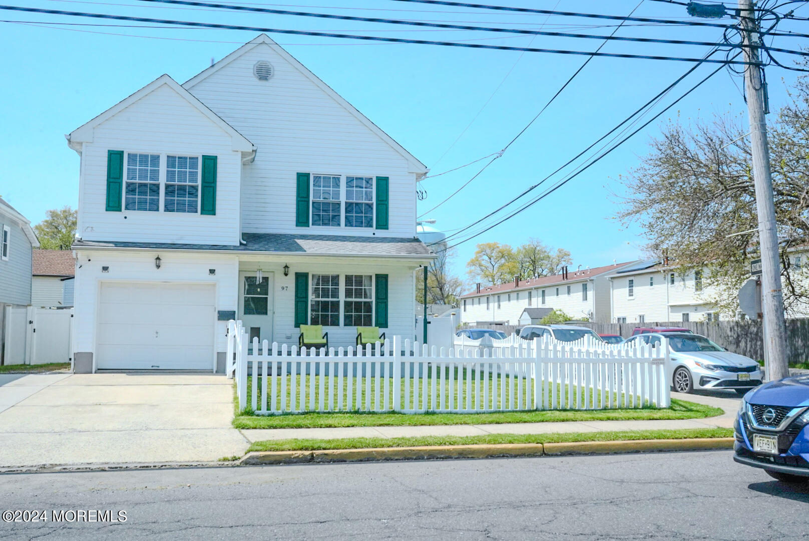 a view of a house with a small yard and plants