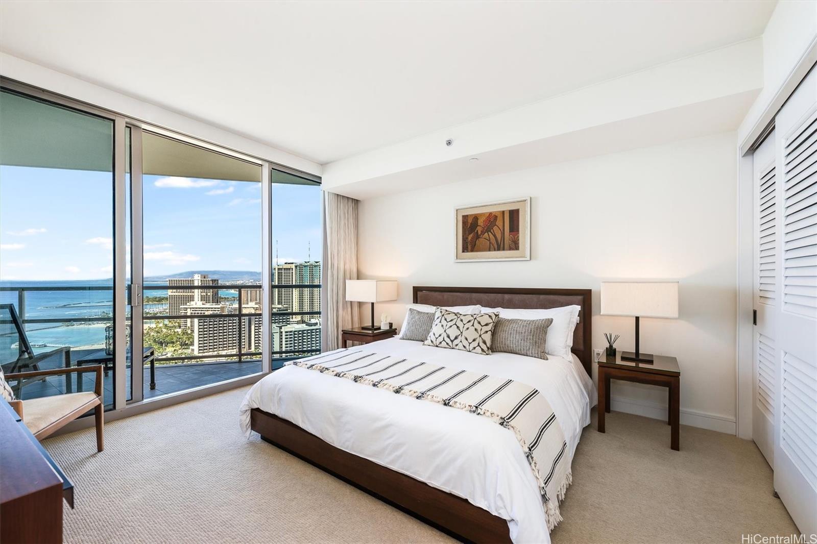 a bedroom with a large bed and a large window