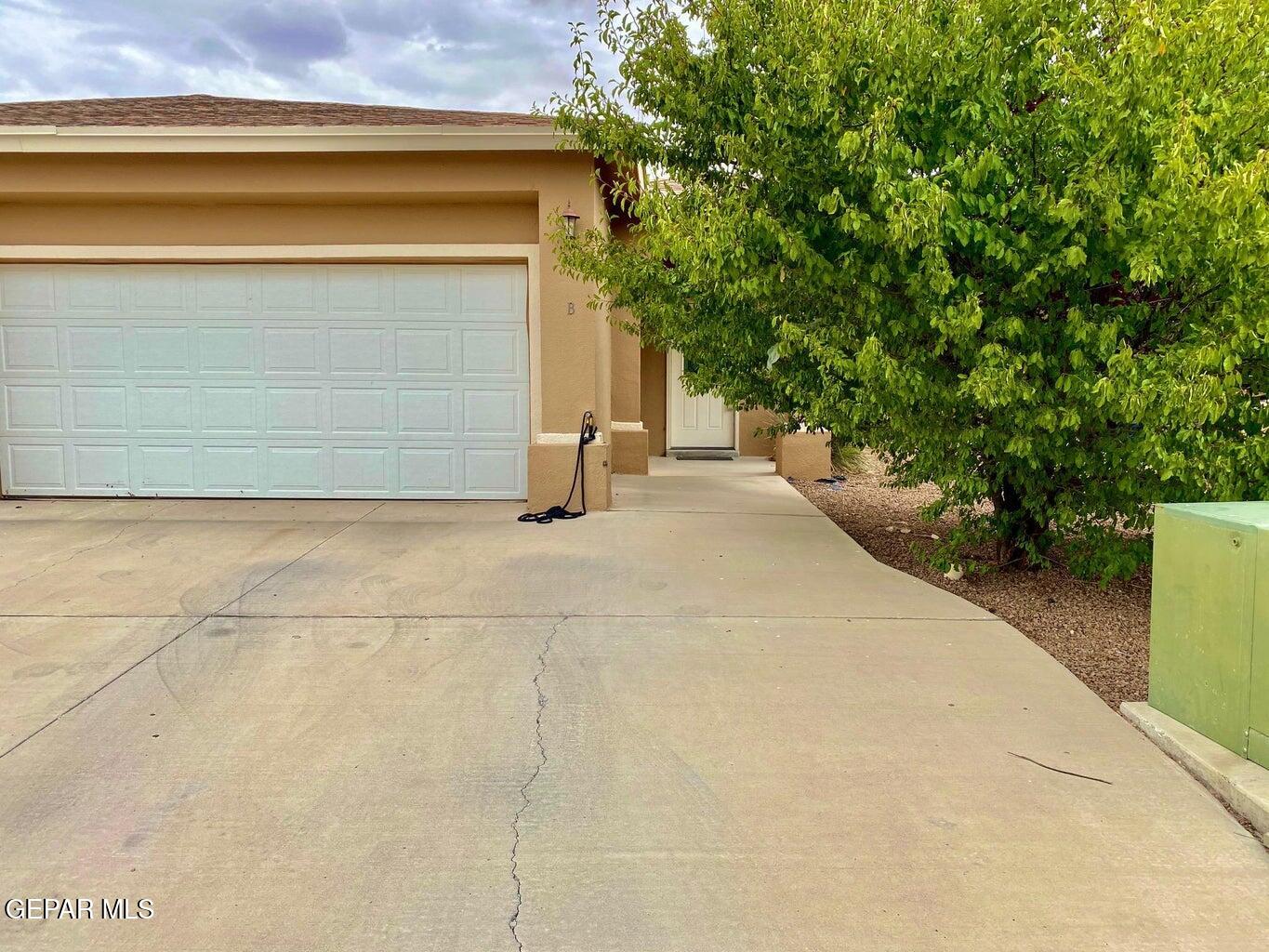 a view of a house with a yard and garage