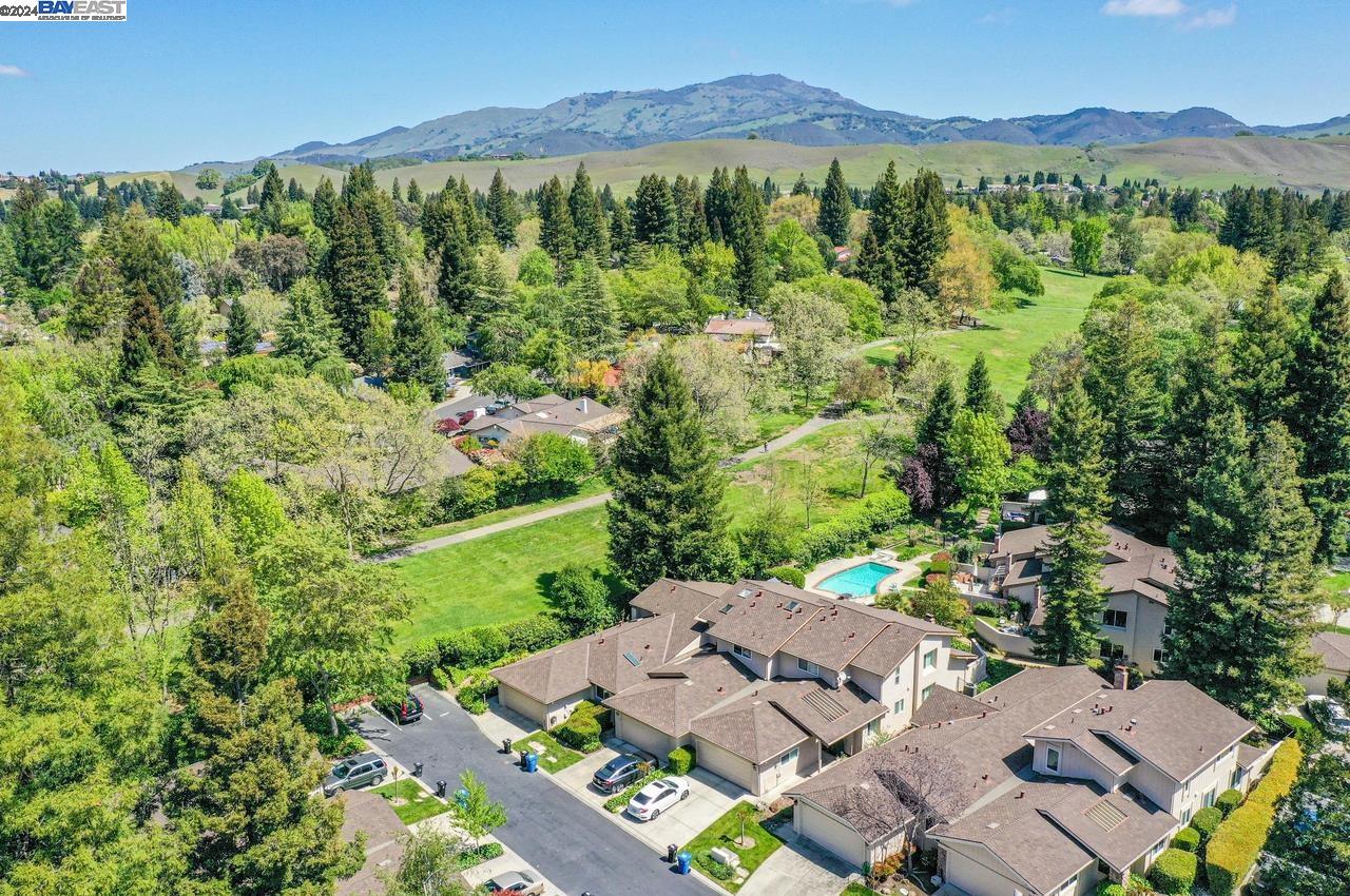 an aerial view of a house with a yard