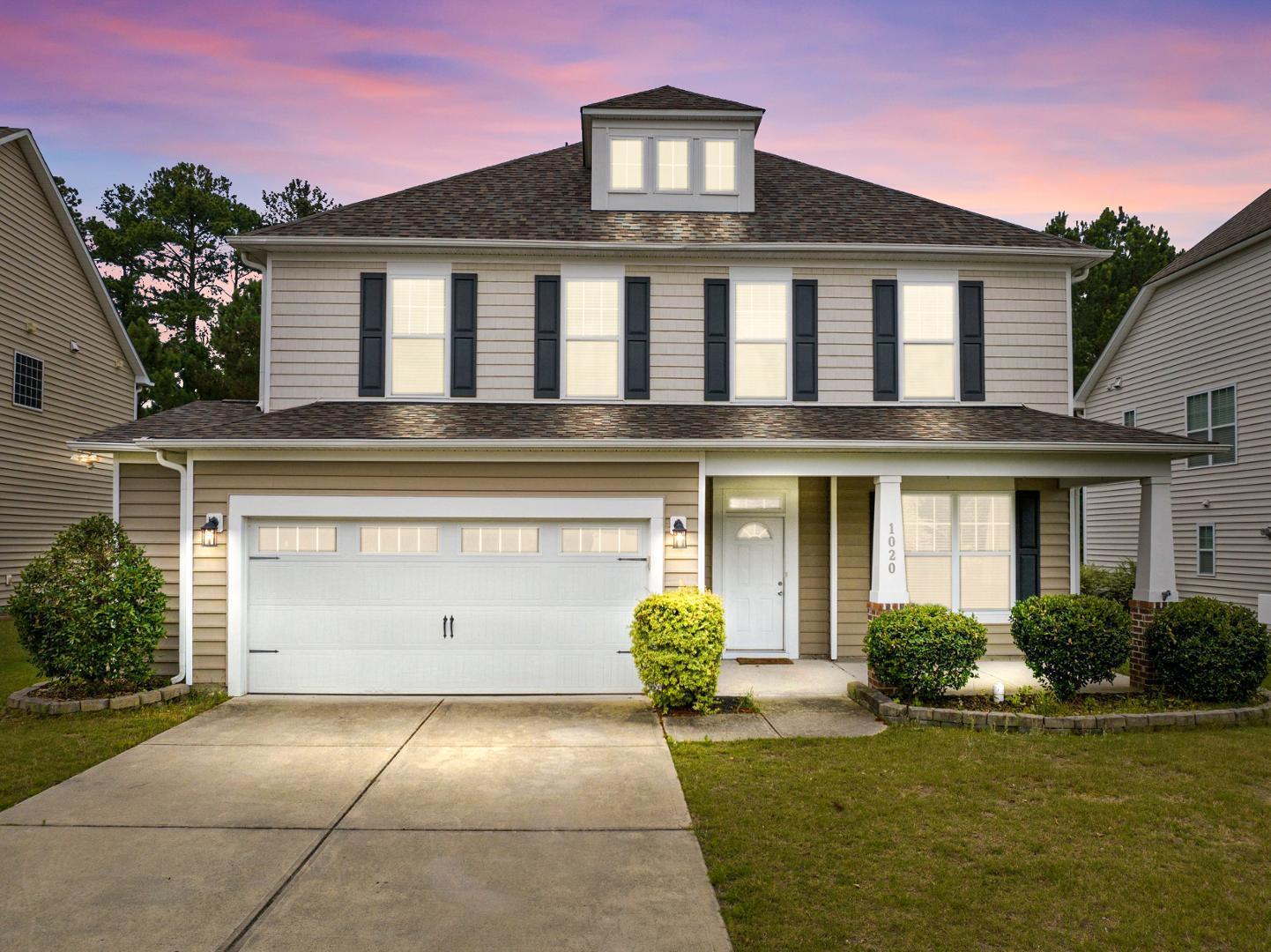 a front view of a house with garden