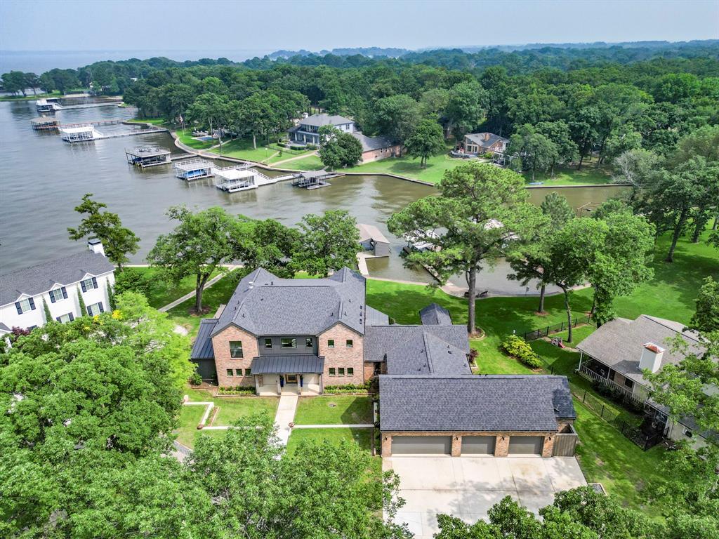 an aerial view of a house with garden space and lake view