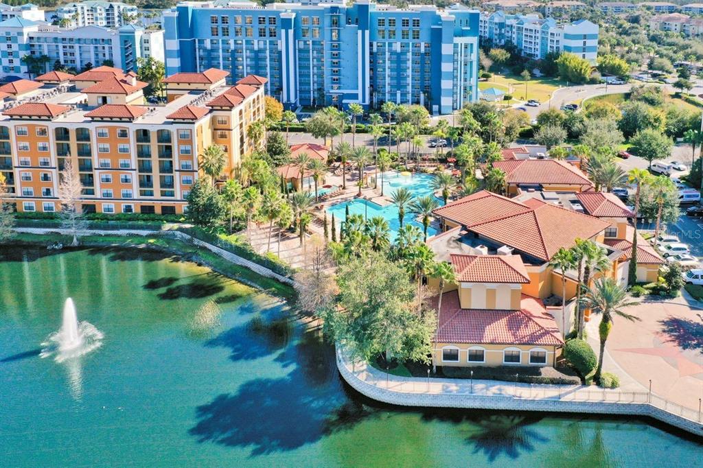 a aerial view of a house with a garden and lake view