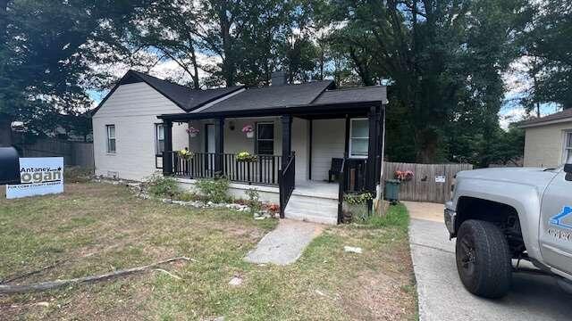 a view of a house with a porch and furniture