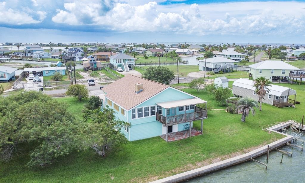 an aerial view of a house with swimming pool garden and patio