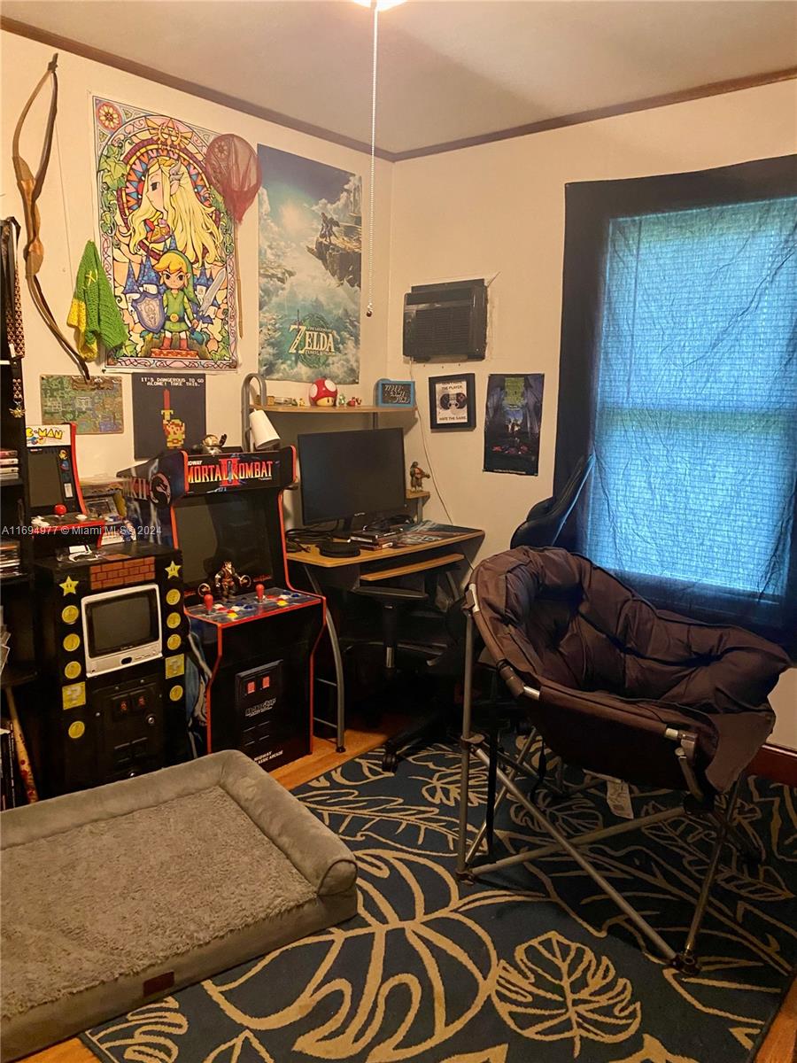 a bedroom with a bed and a flat tv screen on the dresser