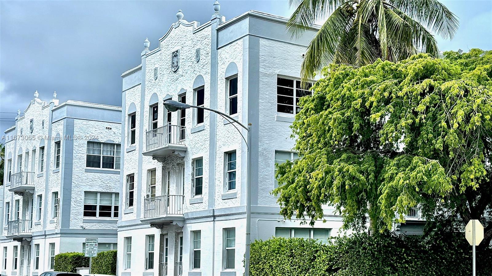 a view of a large building with many windows and plants