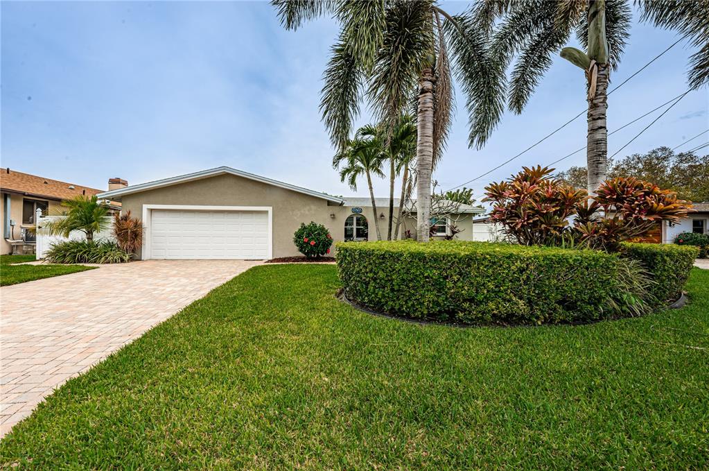 Mature landscaping and a paver driveway give this home extra curb appeal.