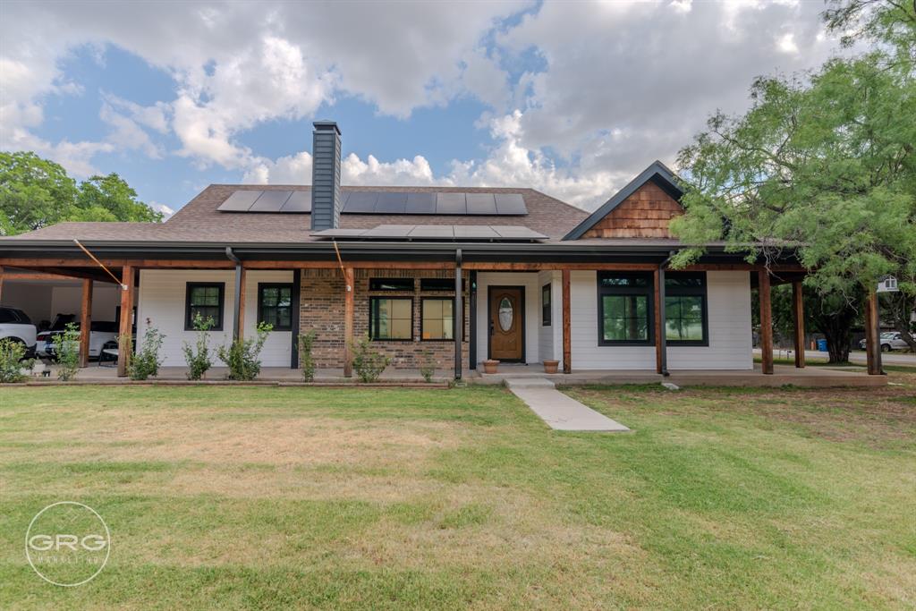 a front view of a house with a garden and porch