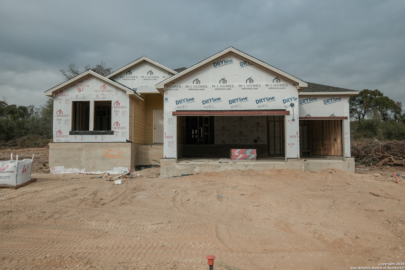 a view of a house with a yard and garage