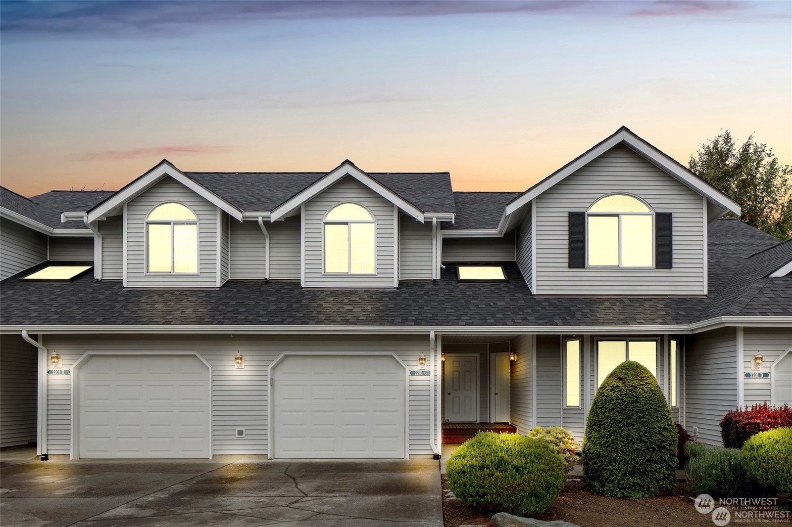 a front view of a house with garage