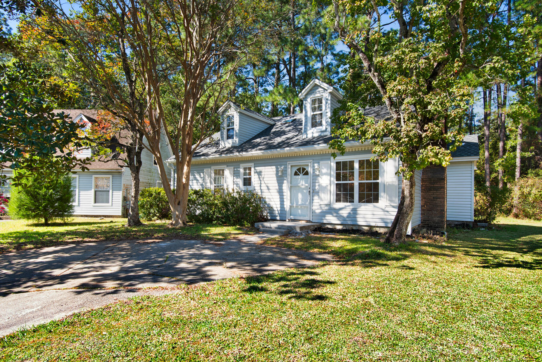 a view of a house with backyard porch and tree