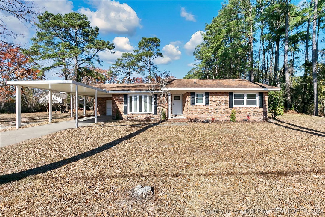 a front view of a house with a yard and trees