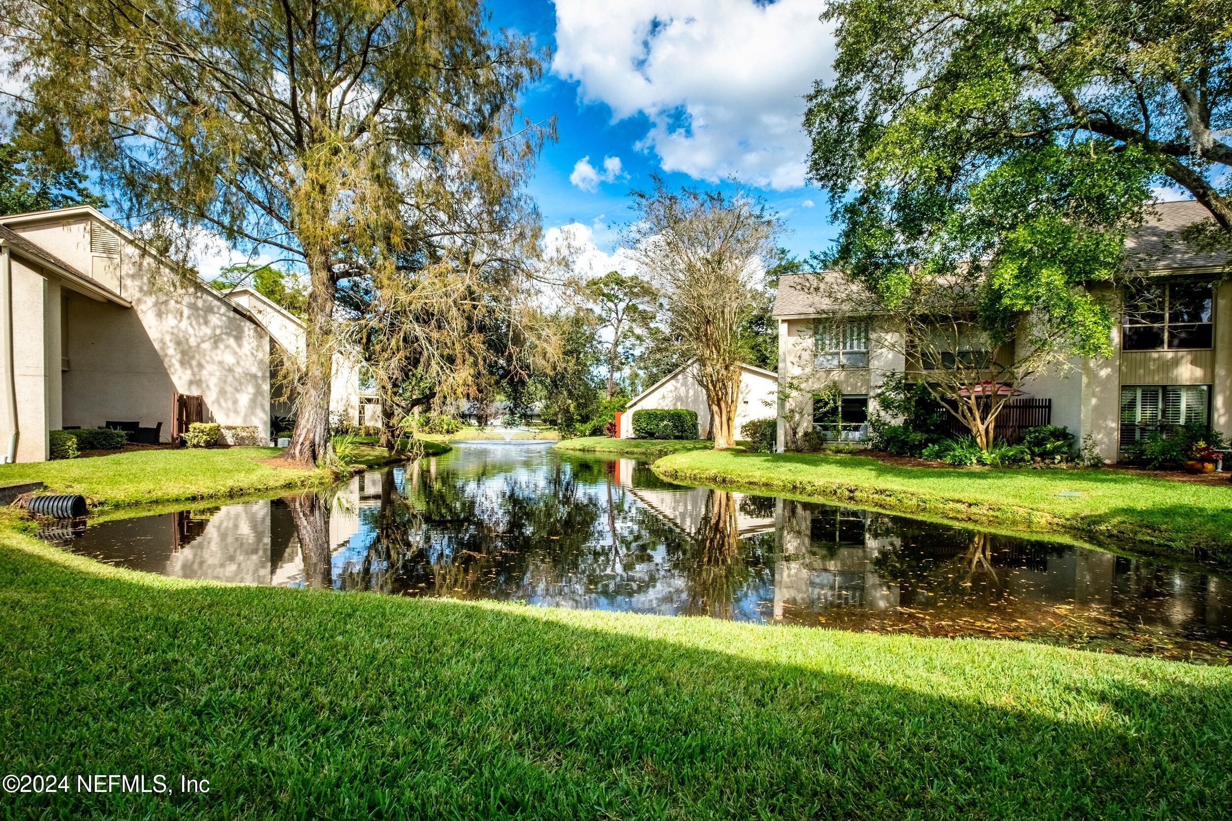 a view of yard with swimming pool and green space