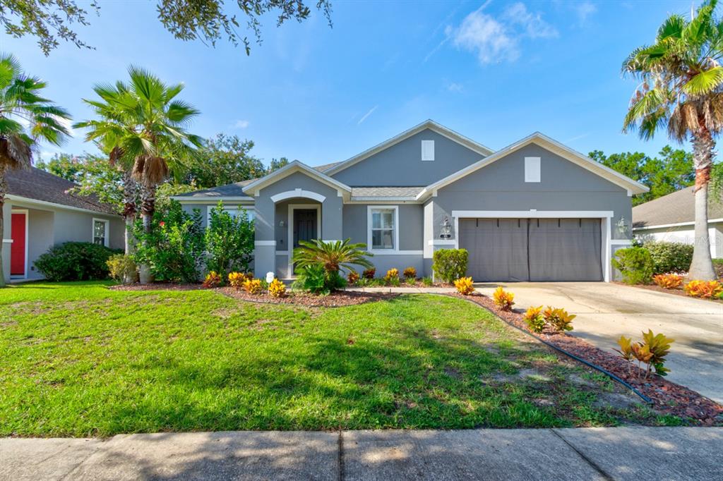 a front view of a house with a yard and garage