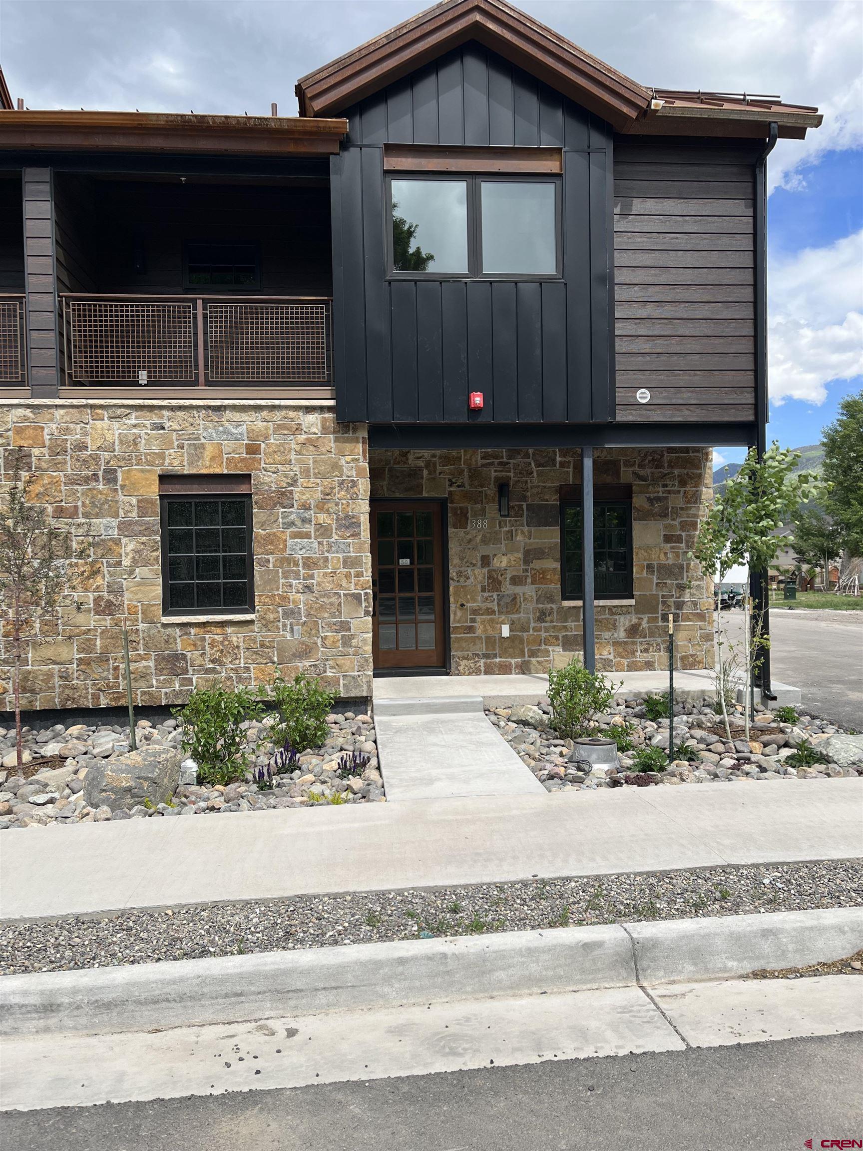 a front view of a house with garage and windows